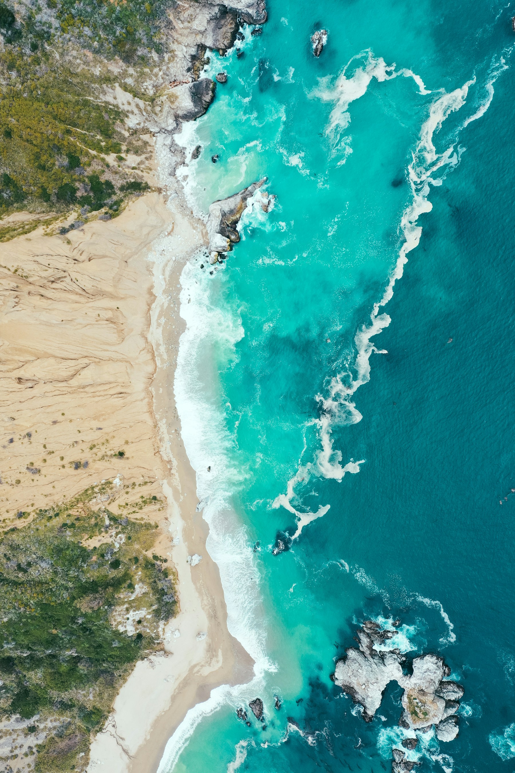 Turquoise ocean meeting a quiet, rugged coastline